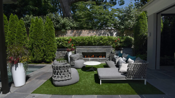 Blade hand-chiseled stone fireplace. Horizontal board fence.